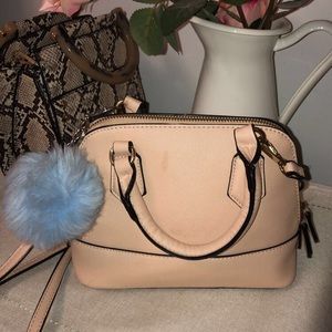 Pink purse with puff ball